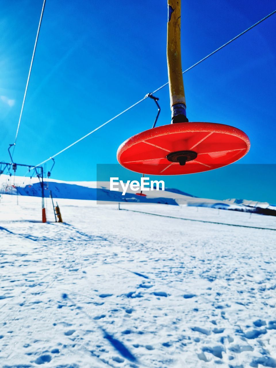 SKI LIFT OVER SNOW COVERED FIELD
