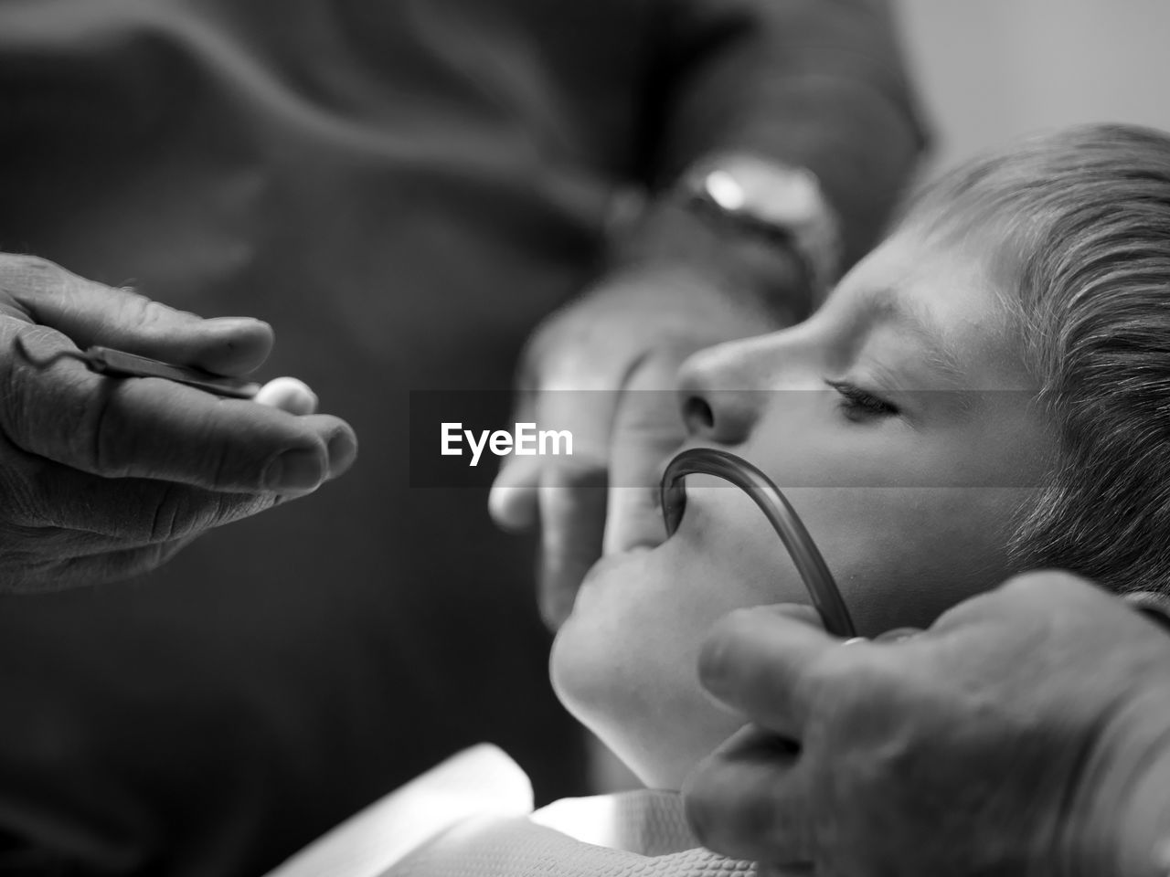 Close-up of dentist examining teeth of boy at clinic