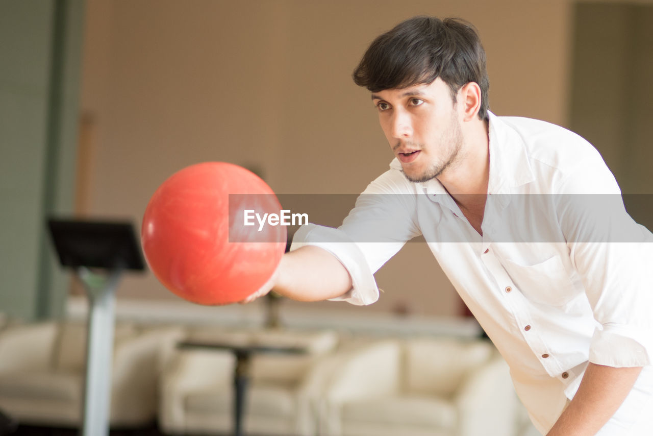 Young man holding bowling ball