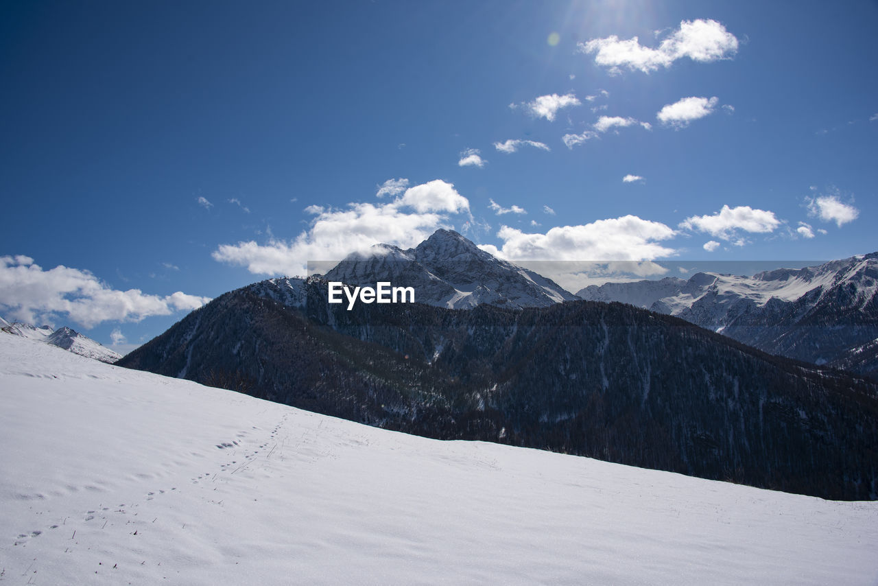 Scenic view of snowcapped mountains against sky