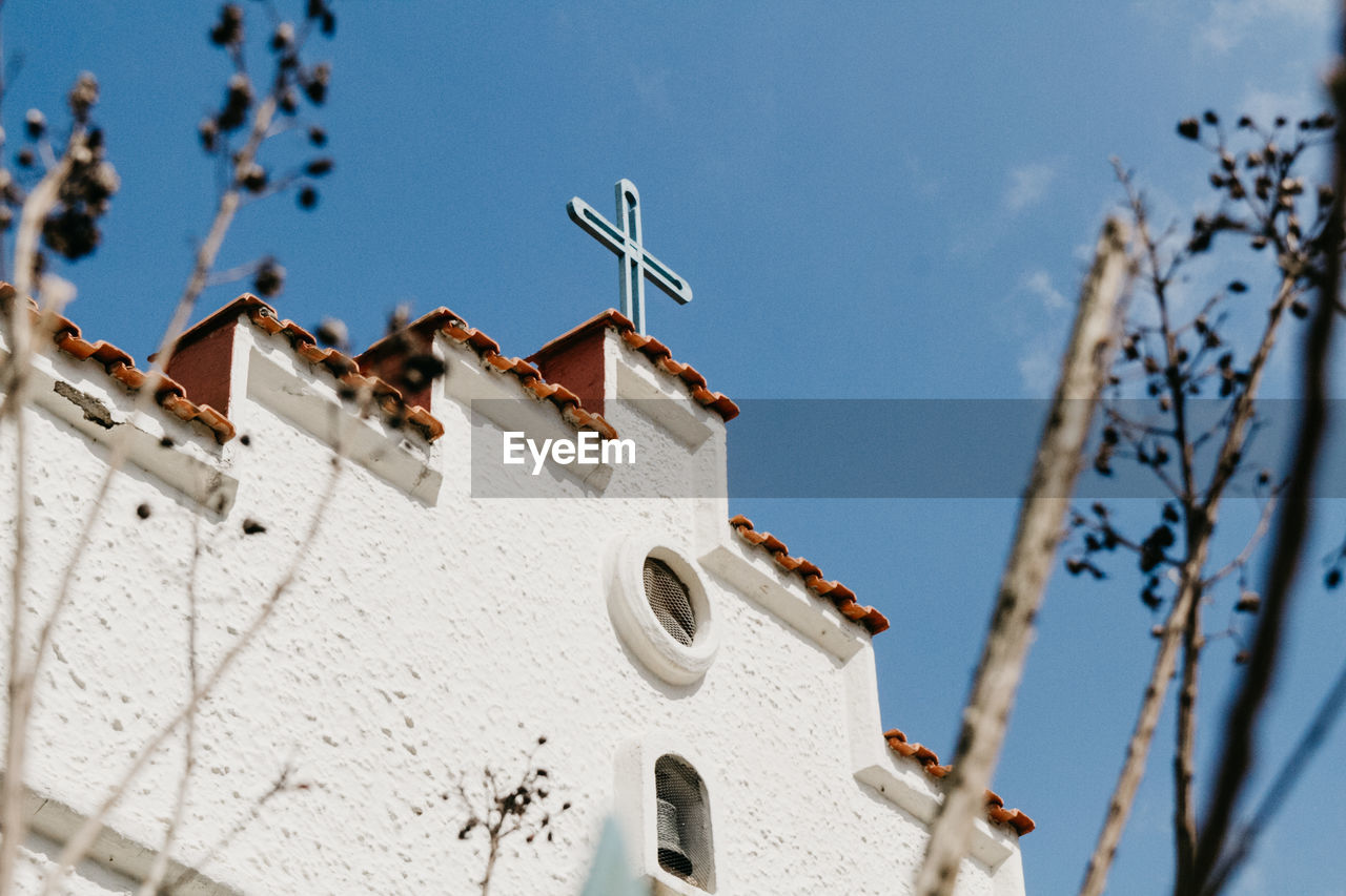 Low angle view of white roof and building against sky