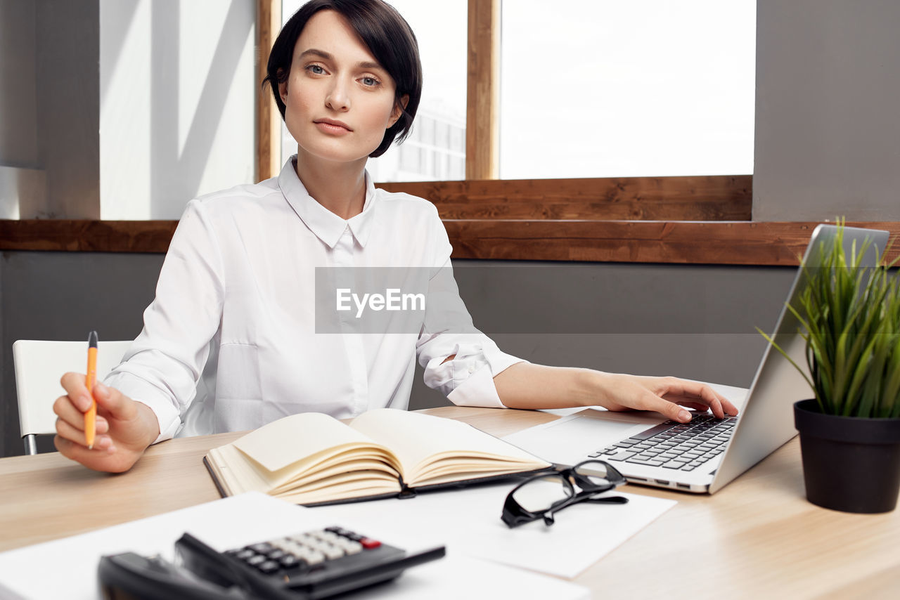 Portrait of businesswoman working at office