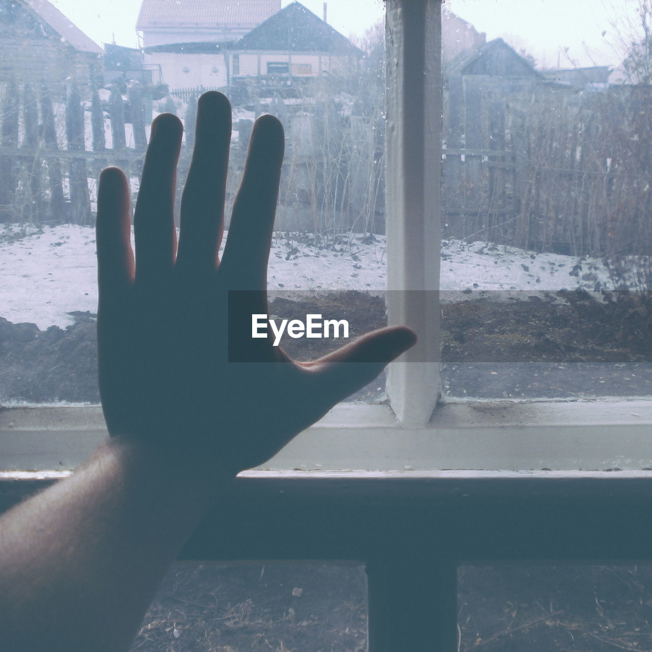 CLOSE-UP OF HUMAN HAND WITH WINDOW IN THE BACKGROUND