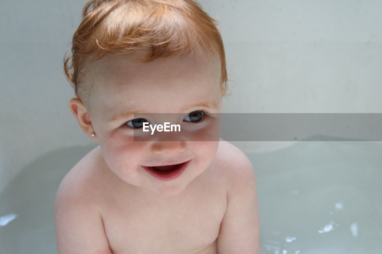 Close-up of cute girl in bathtub