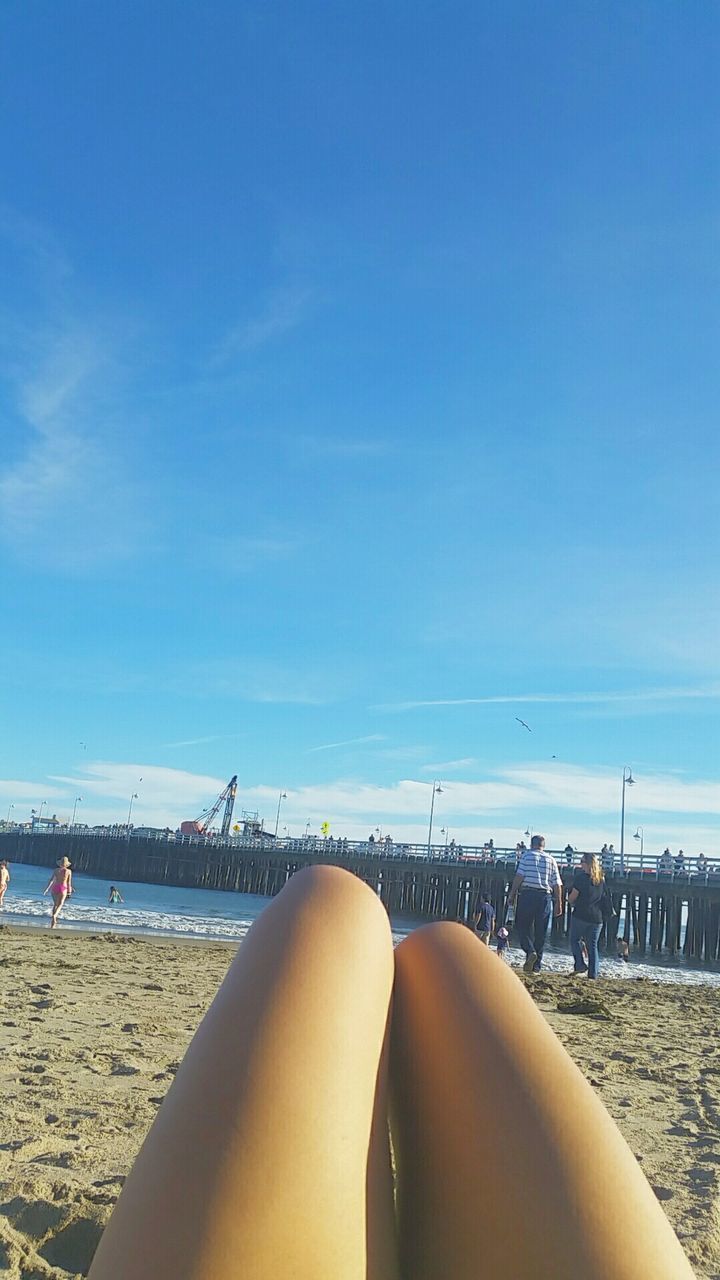 Close-up of human leg at beach