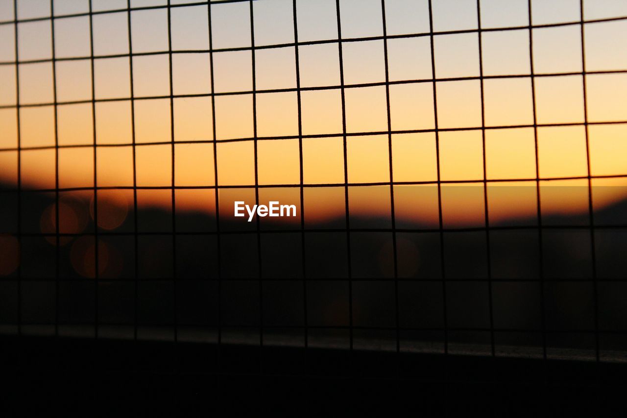 CLOSE-UP OF ORANGE SKY SEEN THROUGH YELLOW DURING SUNSET