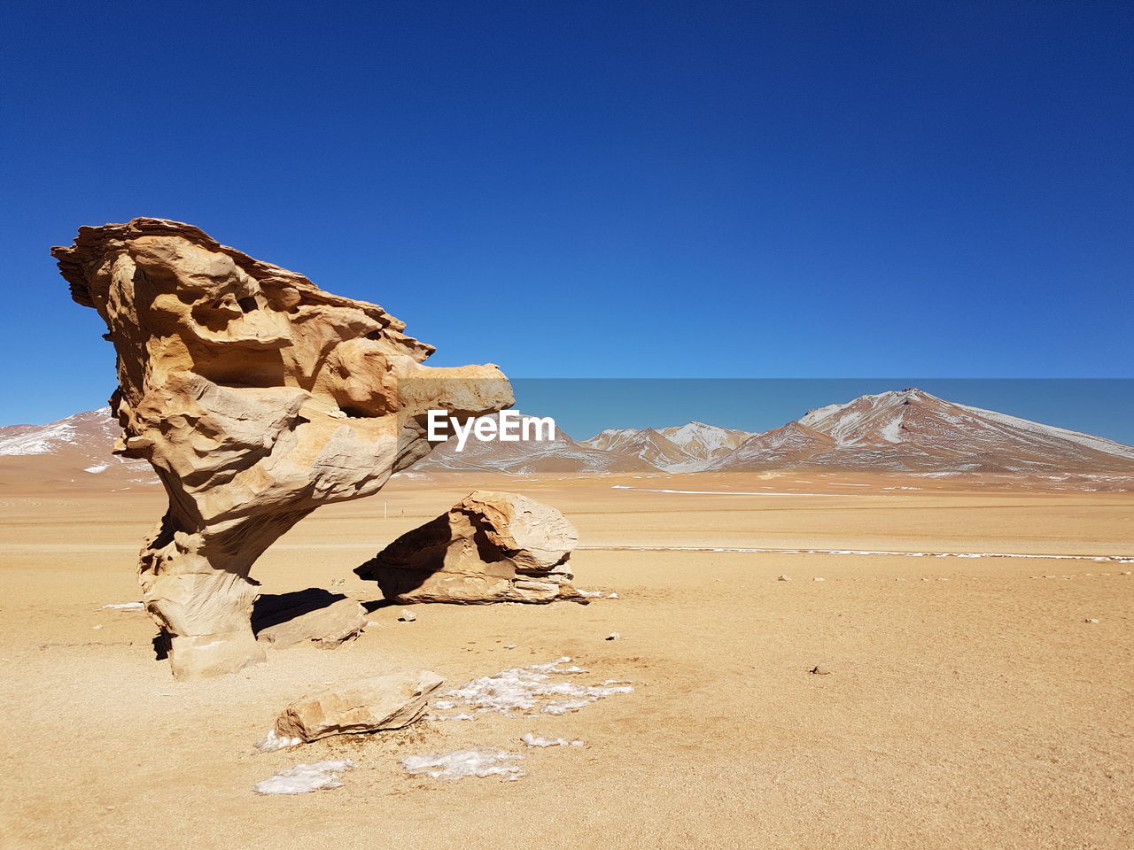 Rock formations in desert against clear blue sky