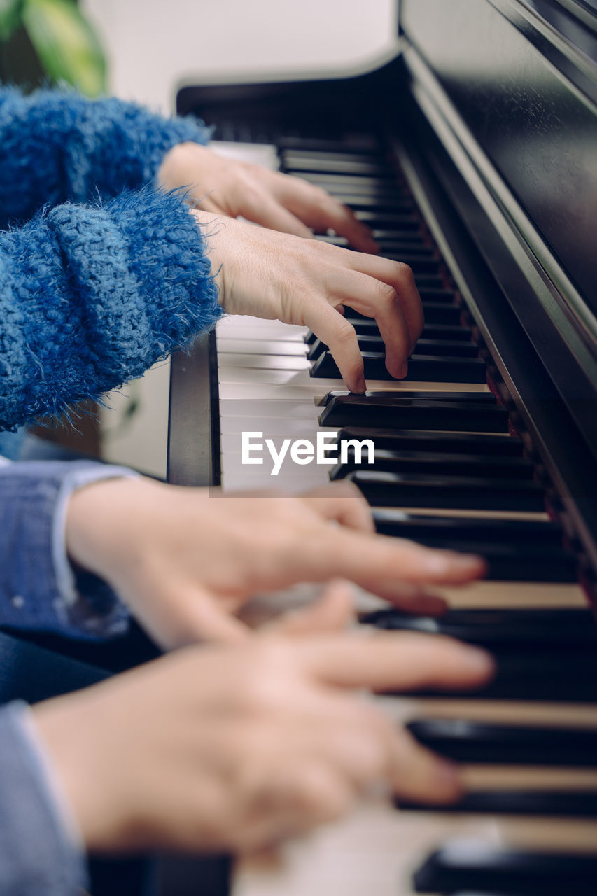 Cropped image of women playing piano