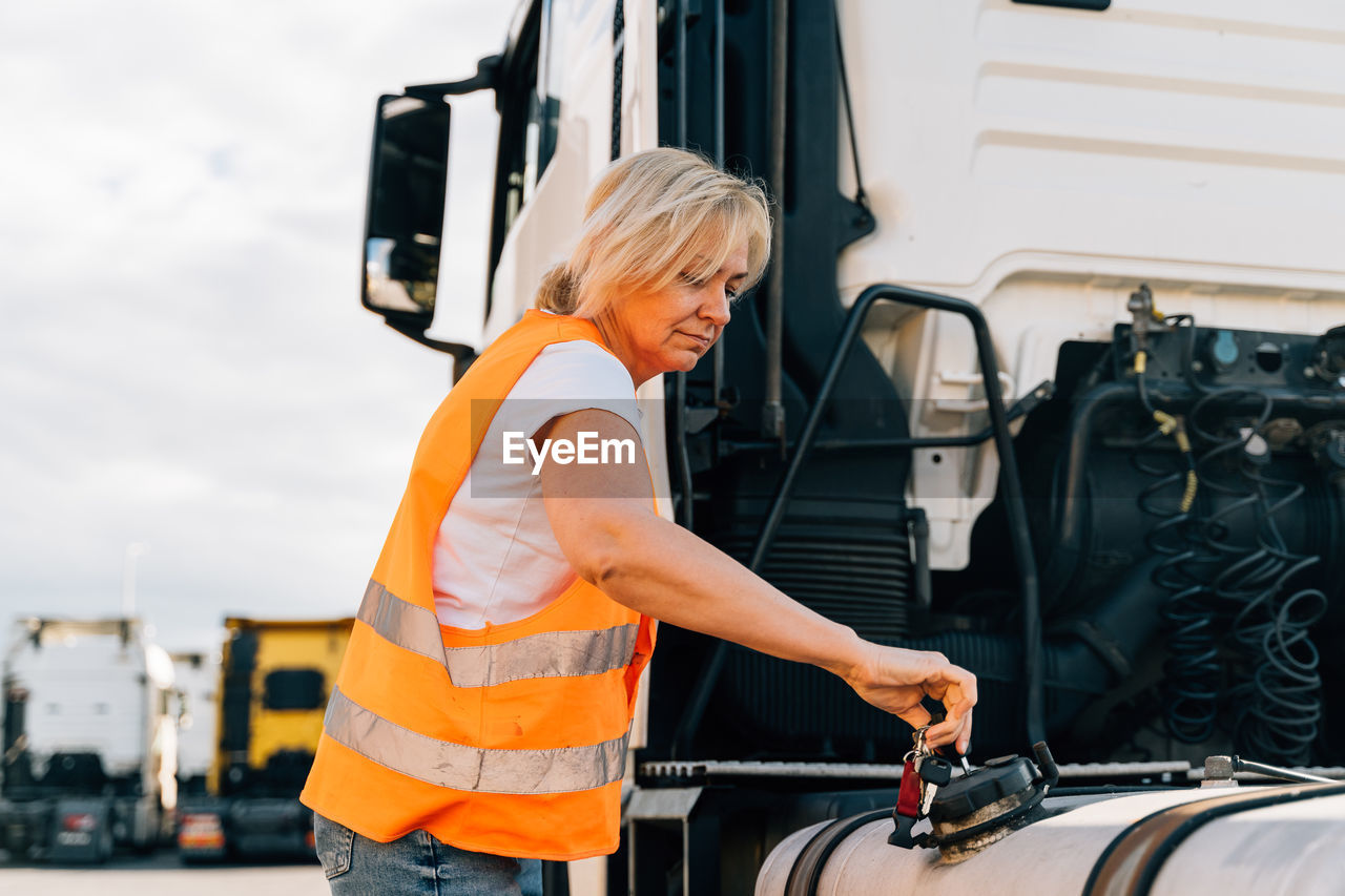 Driver opening tank of truck