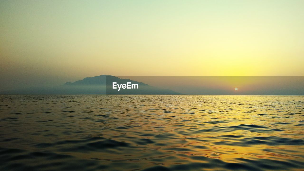 Scenic view of sea against clear sky during sunset