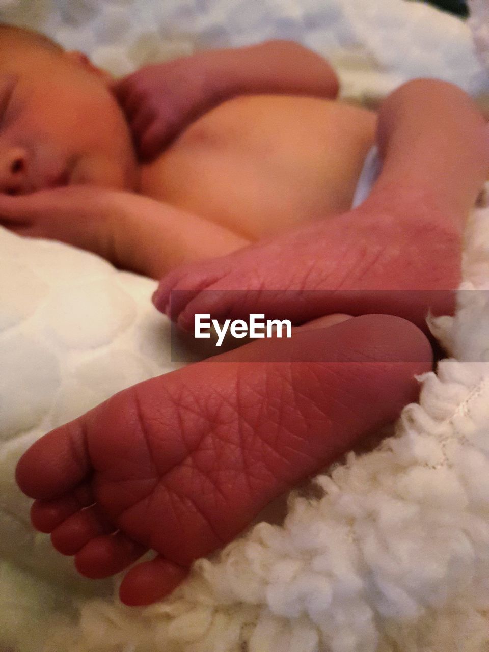 Close-up of baby sleeping on bed