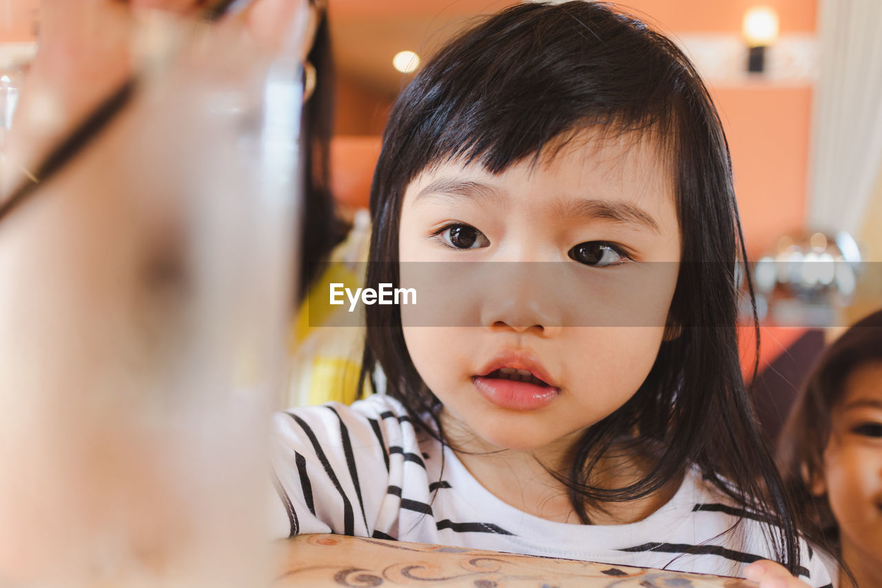 Close-up of girl at table in restaurant