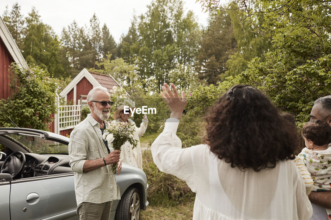 Family meeting near car