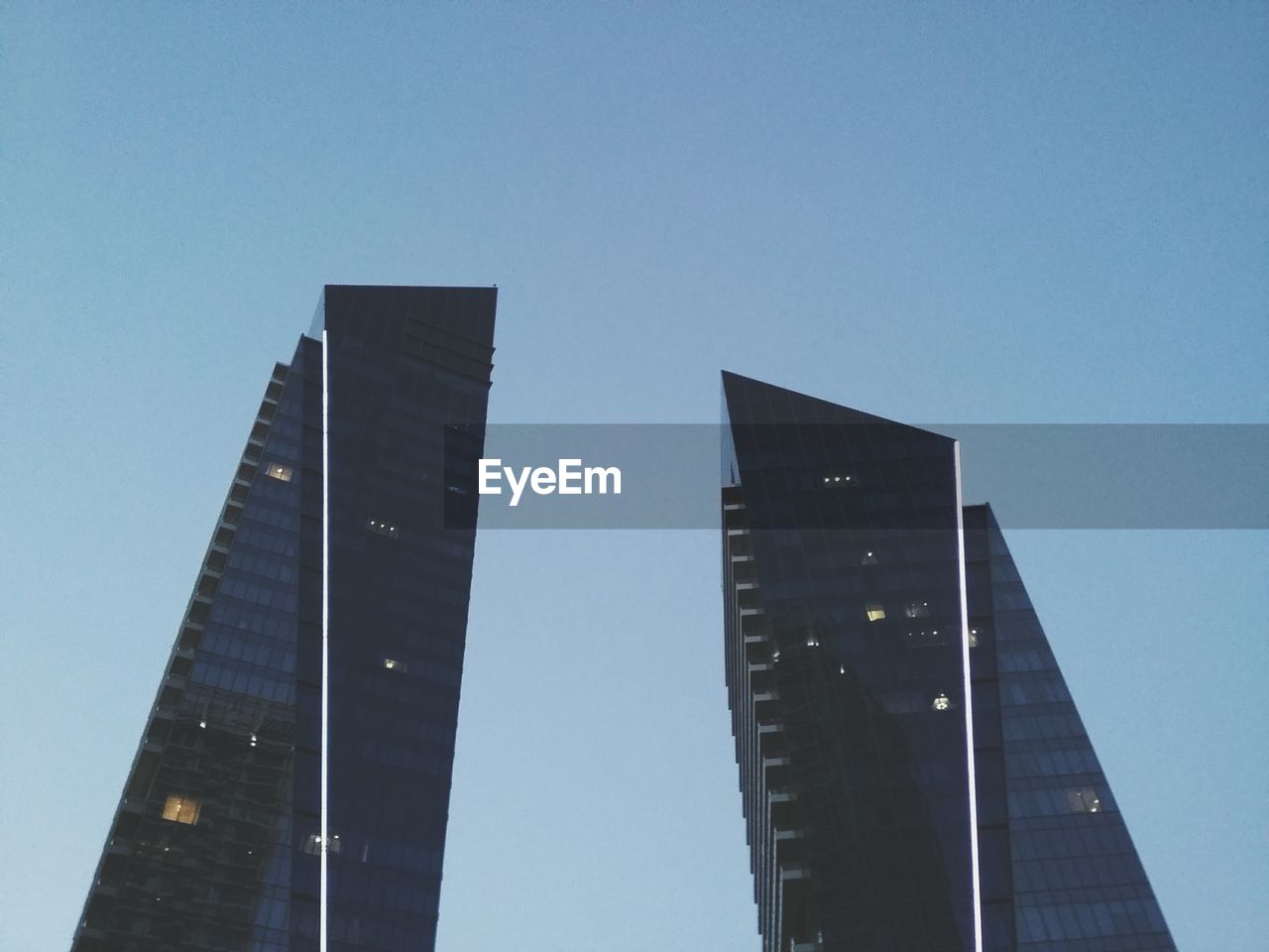 LOW ANGLE VIEW OF MODERN BUILDINGS AGAINST CLEAR SKY