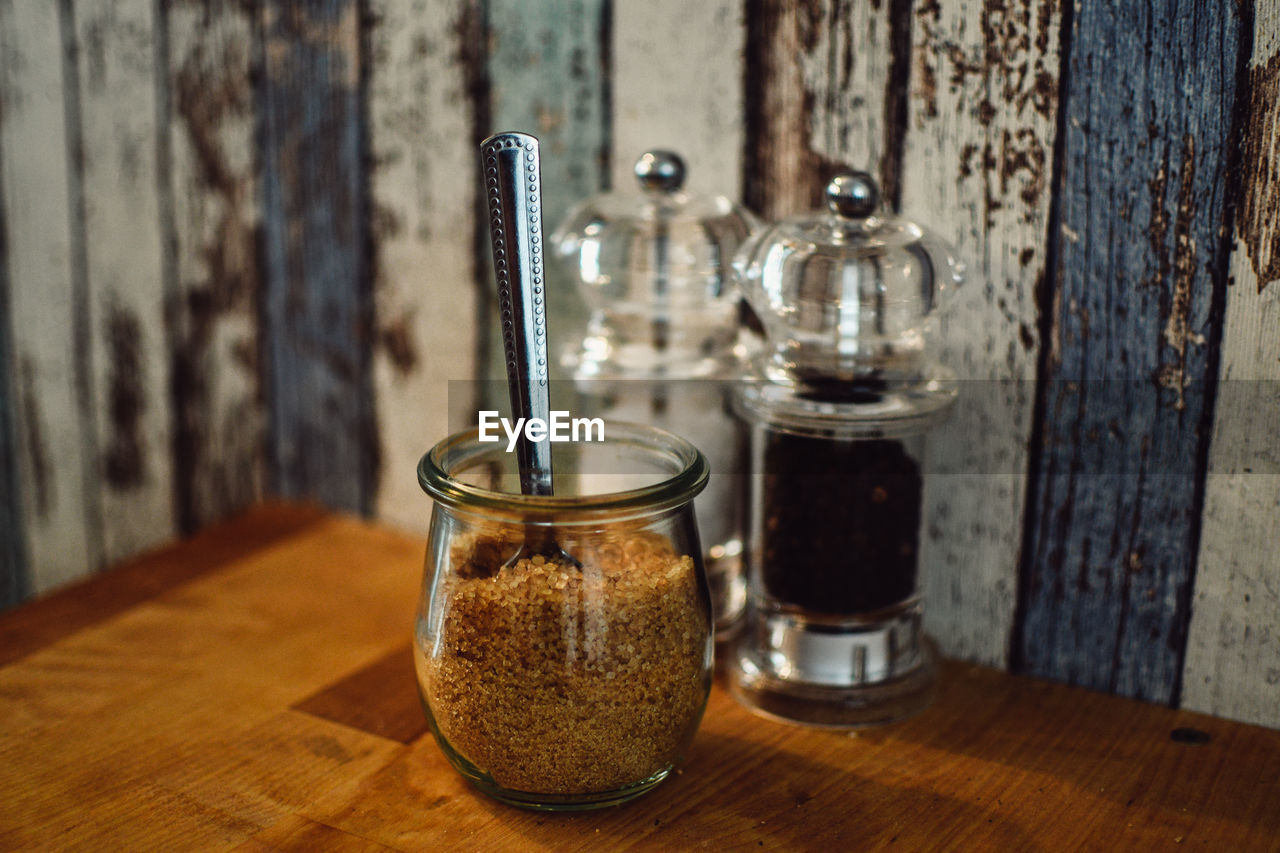 Close-up of brown sugar in glass jar on table
