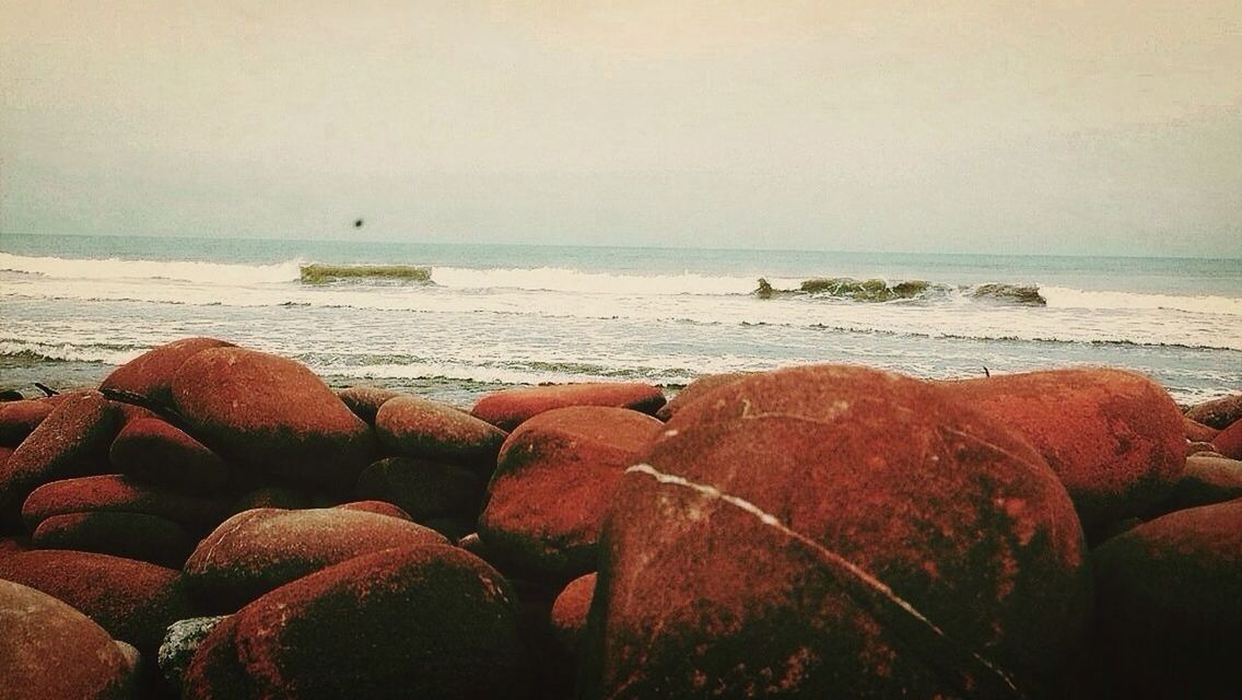 SCENIC VIEW OF SEA WITH ROCKS IN BACKGROUND