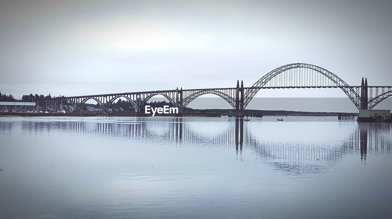 Scenic view of yaquina bay bridge over water against sky