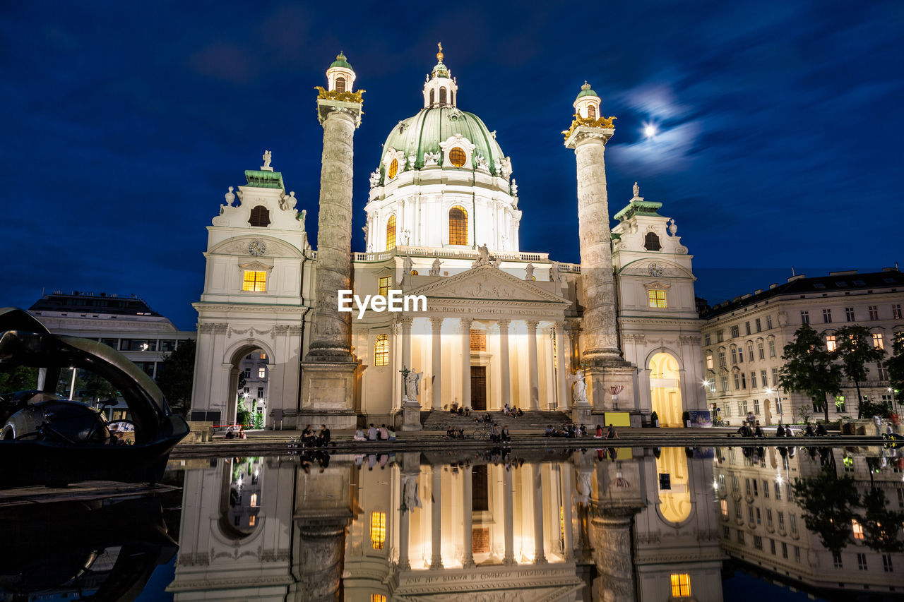 LOW ANGLE VIEW OF ILLUMINATED BUILDINGS AGAINST SKY