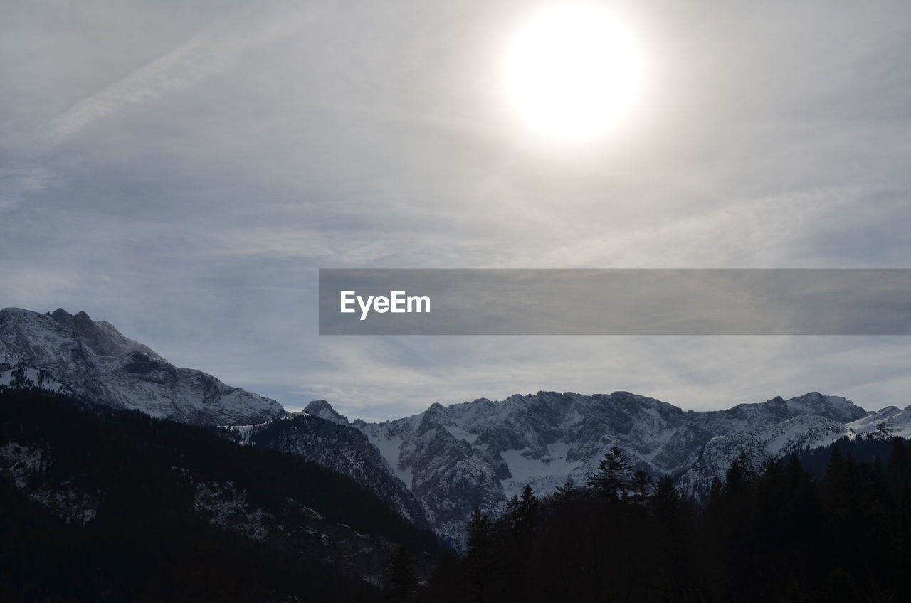 SCENIC VIEW OF SNOWCAPPED MOUNTAINS AGAINST BRIGHT SKY