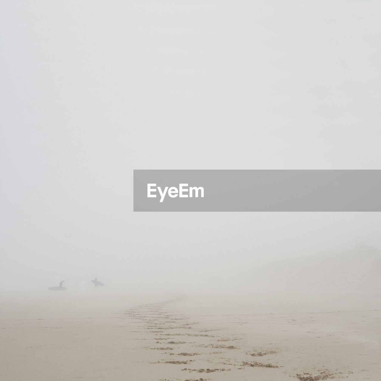 Scenic view of beach against sky during foggy weather