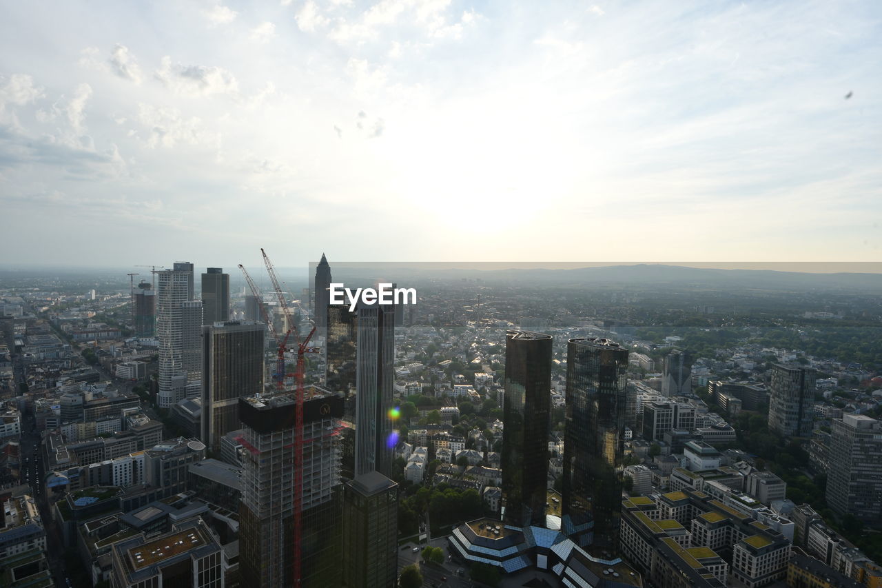 HIGH ANGLE VIEW OF BUILDINGS AGAINST SKY IN CITY