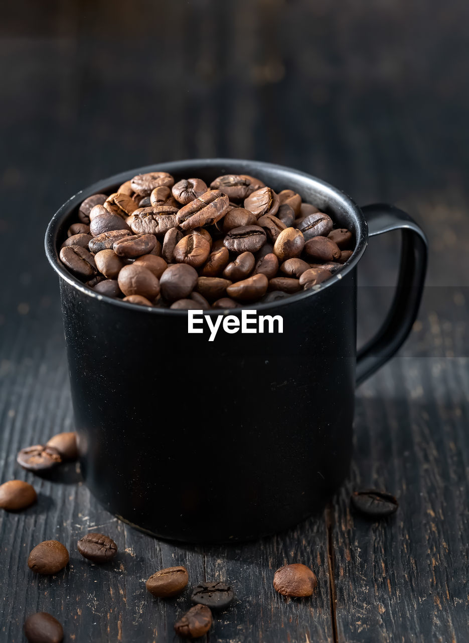 food and drink, food, cup, wood, studio shot, freshness, healthy eating, roasted coffee bean, coffee, dark, drink, no people, coffee cup, indoors, wellbeing, nut - food, nut, still life, rustic, refreshment, brown, sweet food, crockery, produce, table, mug, fruit, copy space, black, close-up, kitchen utensil
