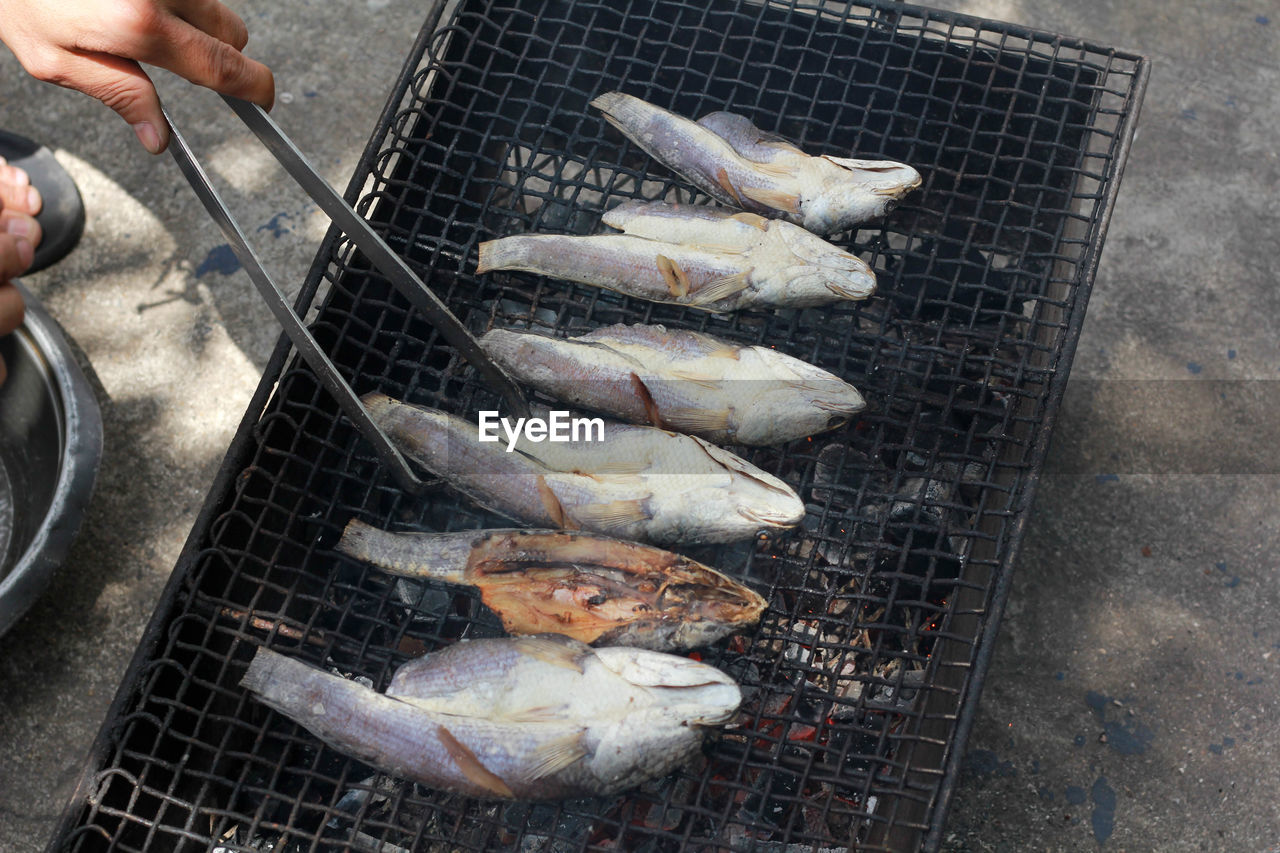 High angle view of fish on barbecue grill