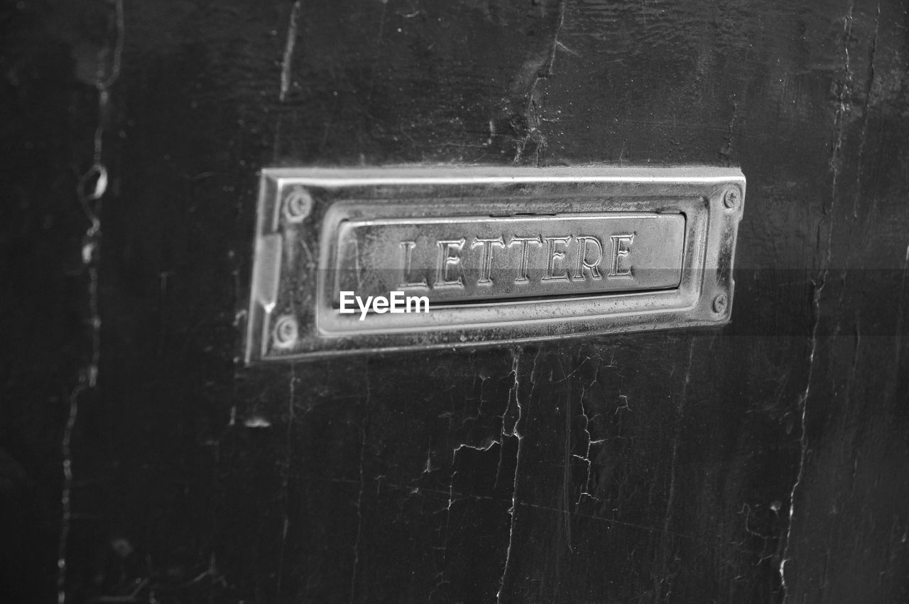 Close-up of mailbox on wooden door