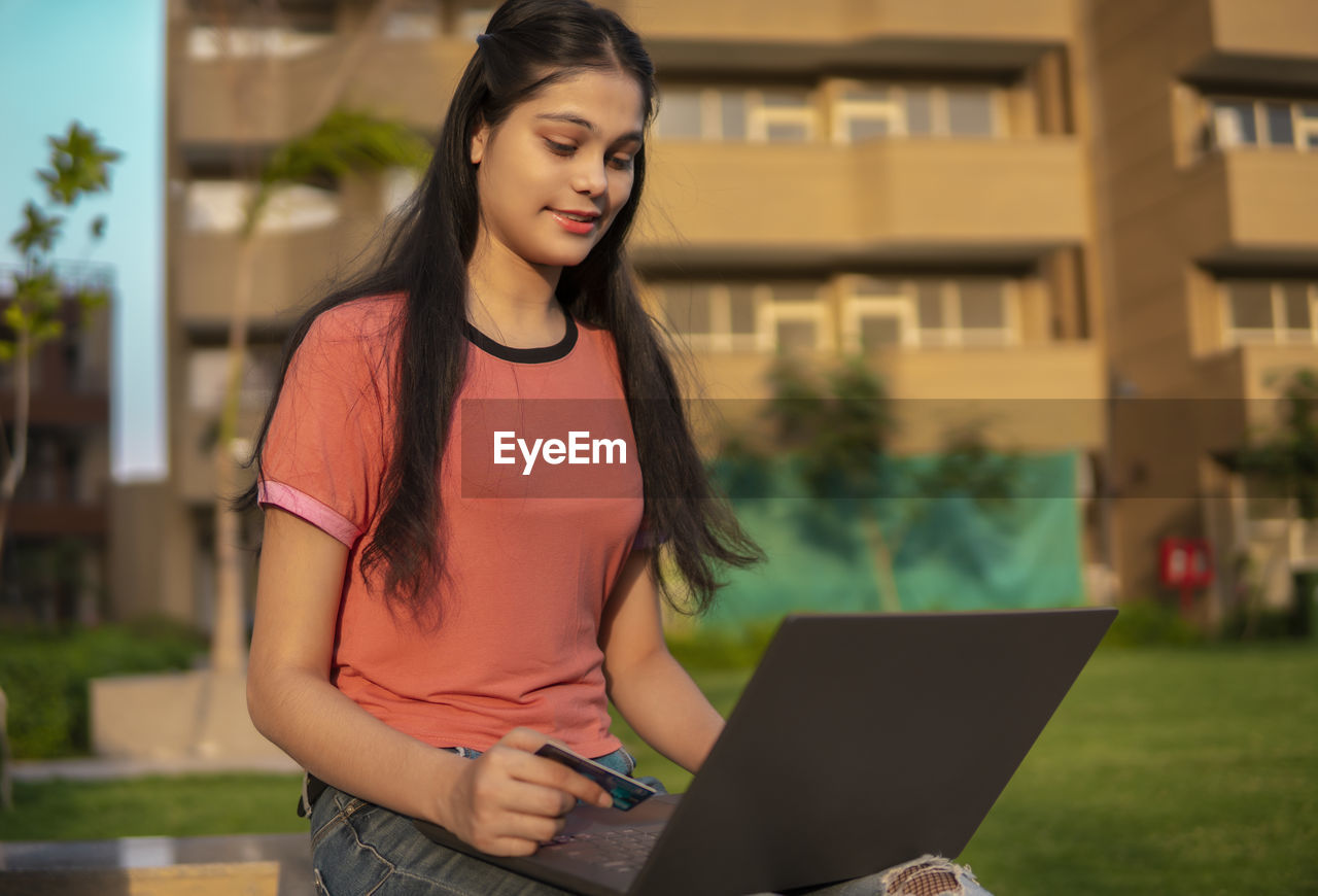 portrait of young woman using mobile phone