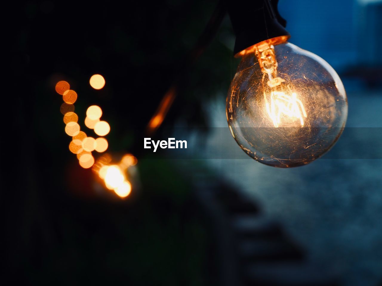 Close-up of illuminated light bulb at night