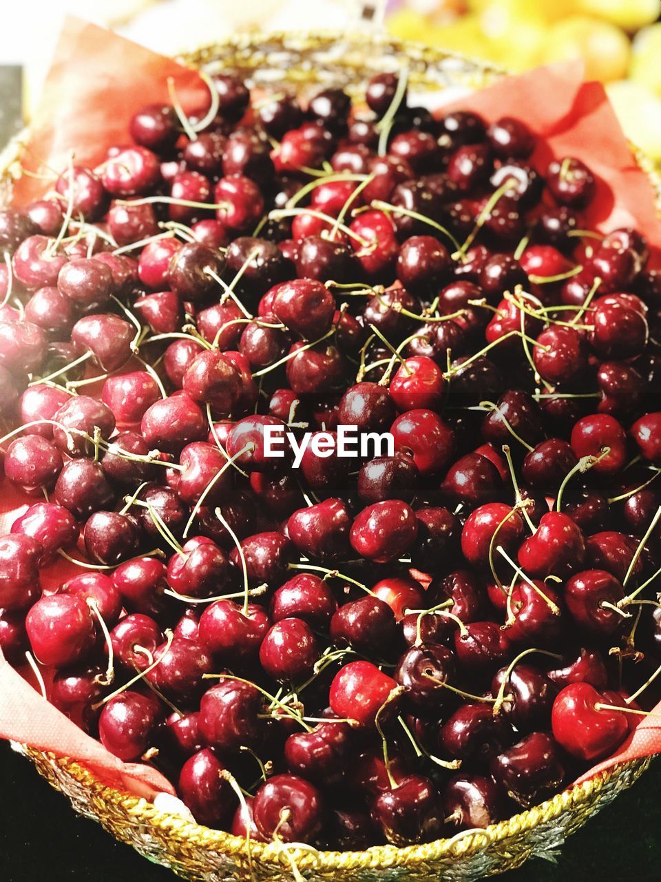 High angle view of cherries in basket for sale at market stall