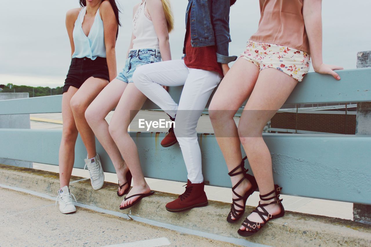 Low section of teenage girls standing outdoors