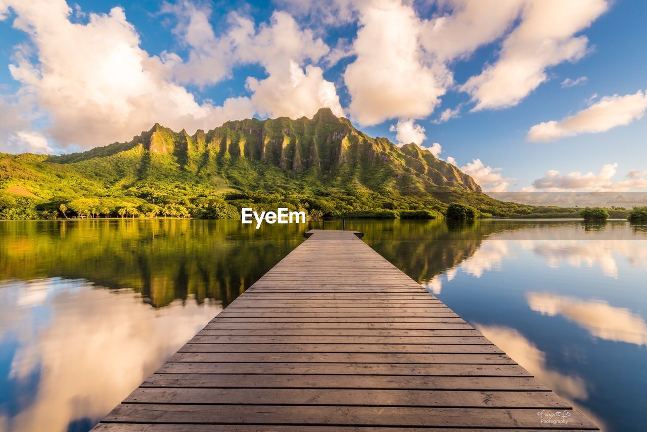 Pier over lake against sky