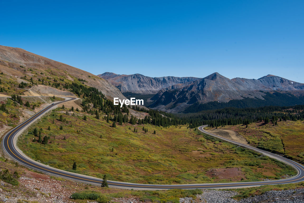 Scenic view of mountains against clear blue sky