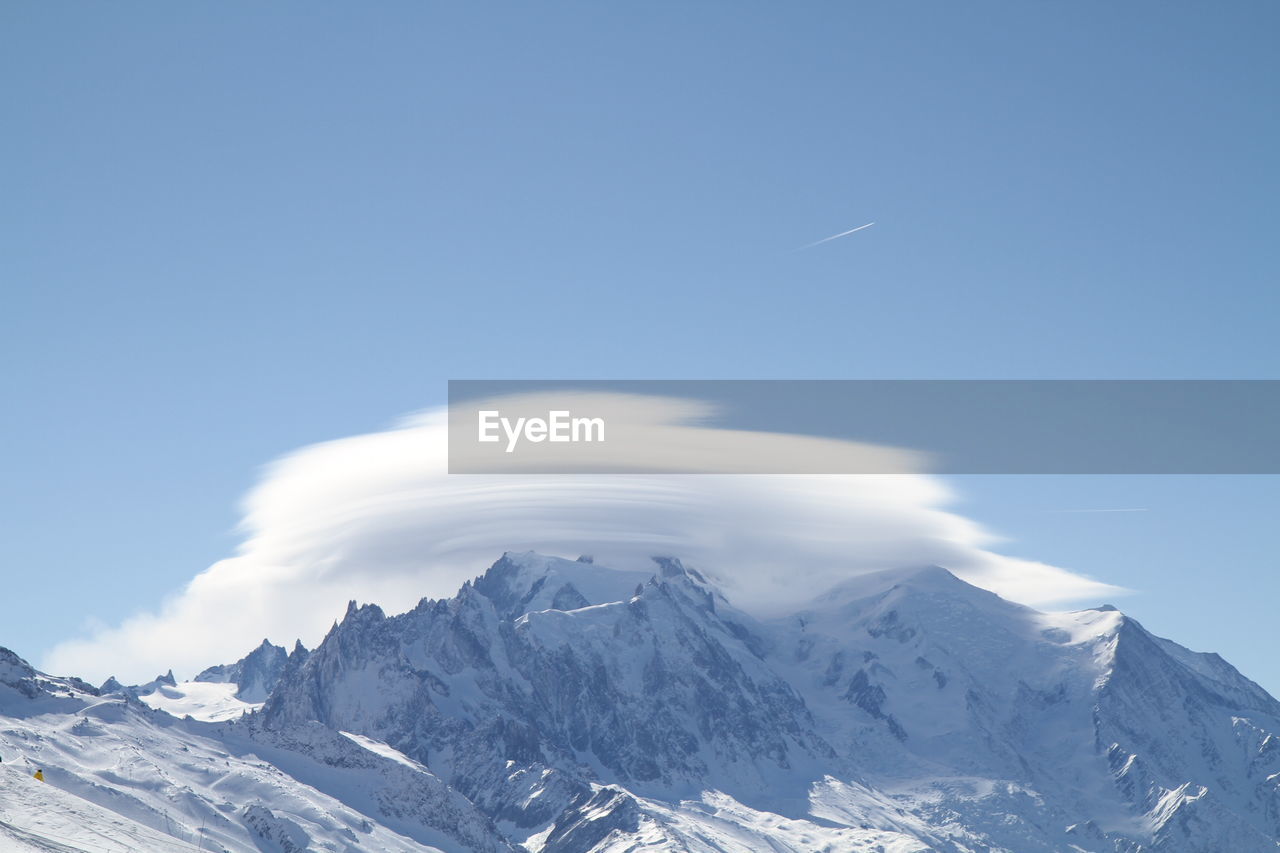 Scenic view of snowcapped mountains against sky