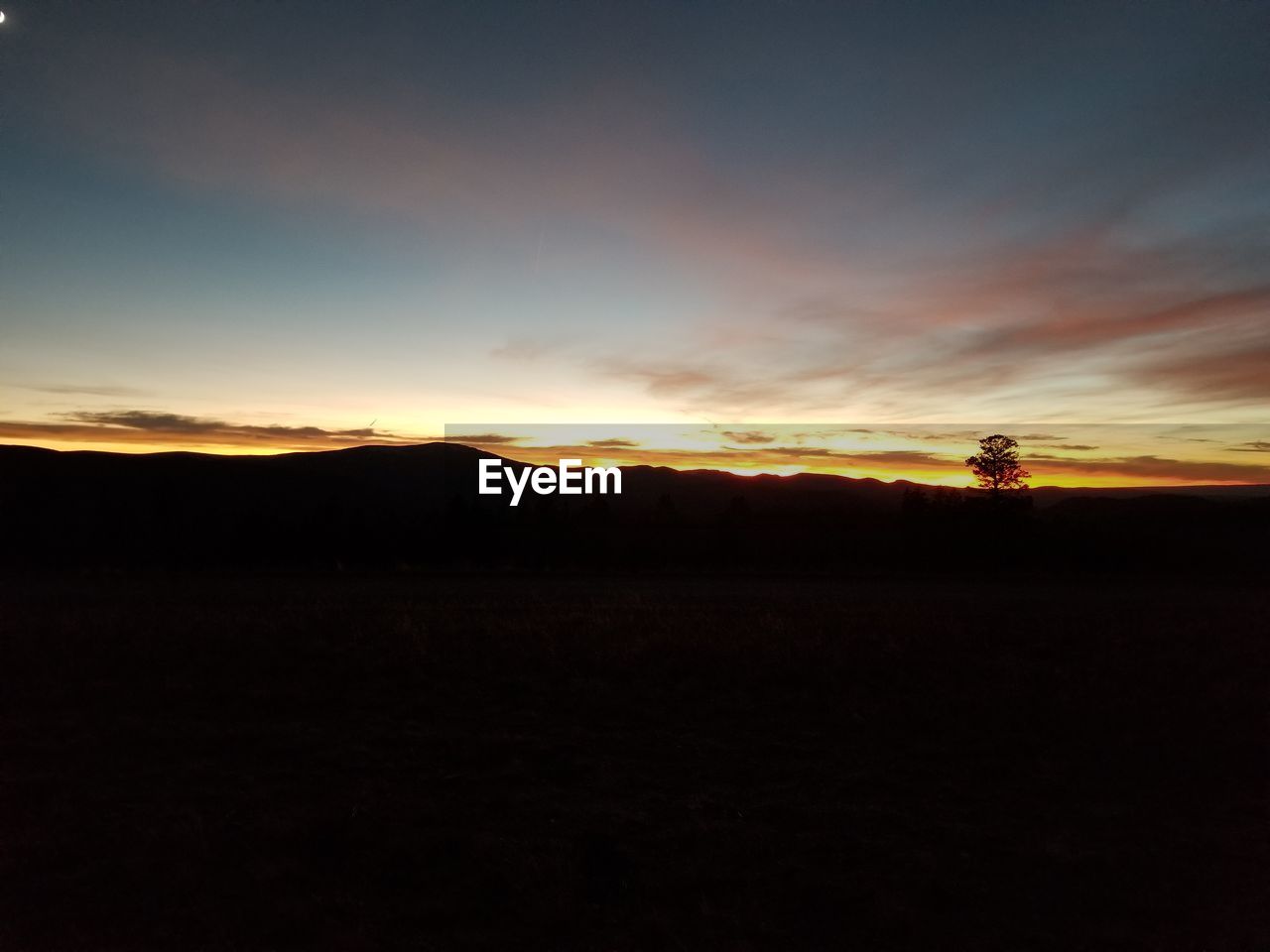 SILHOUETTE LANDSCAPE AGAINST SKY AT SUNSET