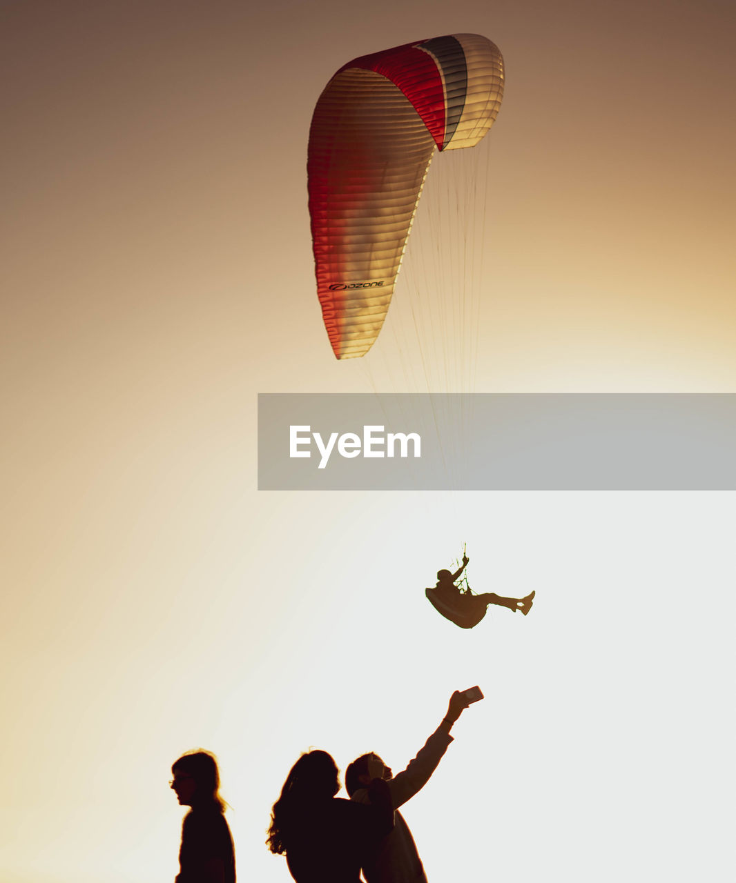 LOW ANGLE VIEW OF PEOPLE PARAGLIDING AGAINST SKY