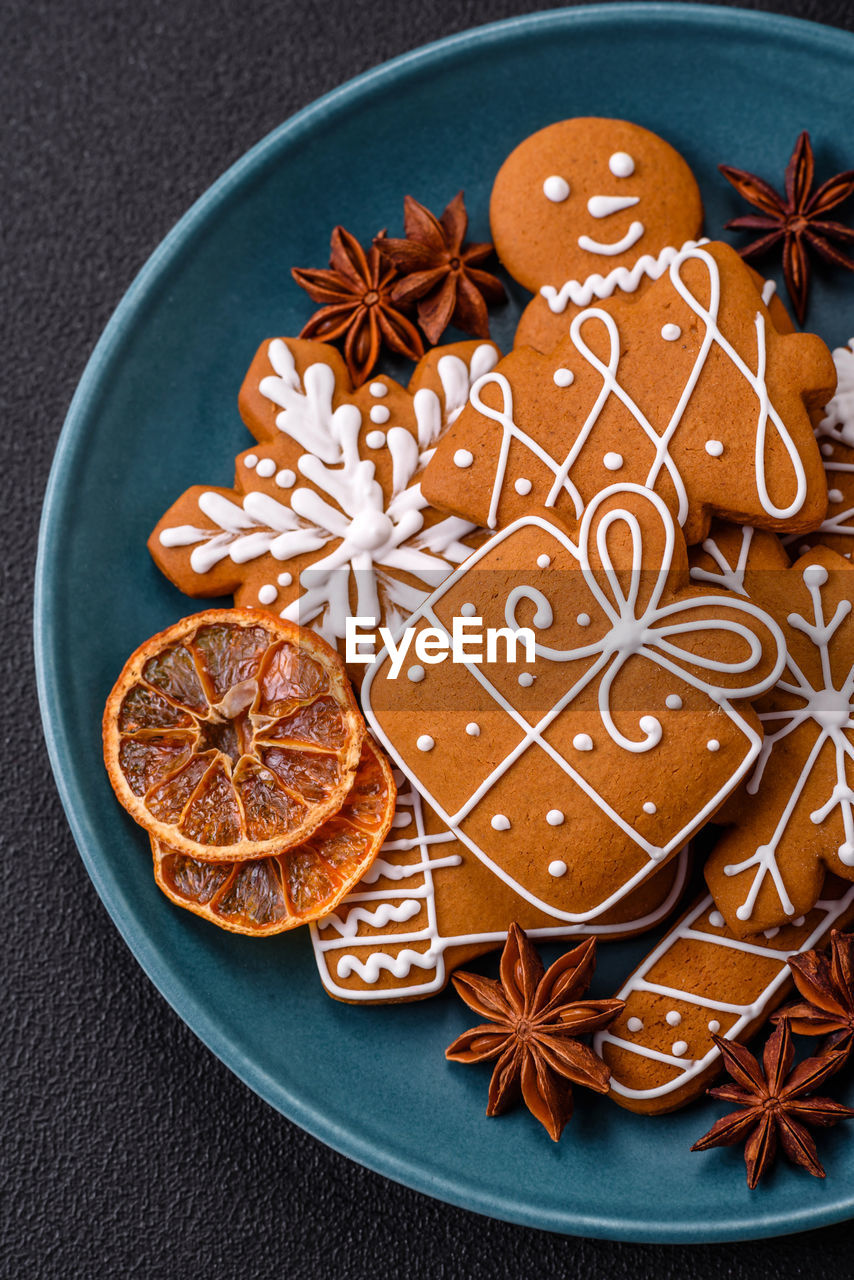 food and drink, food, star anise, holiday, shape, star shape, sweet food, no people, christmas, plate, spice, cinnamon, indoors, high angle view, still life, baked, celebration, cookie, decoration, studio shot, directly above, orange color, biscuit, sweet, dessert, freshness, snack, anise, gingerbread cookie