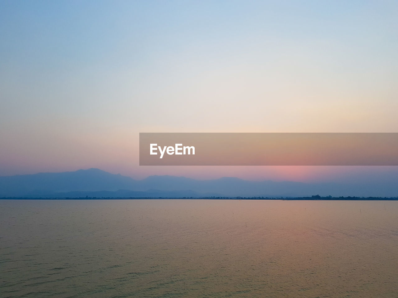 Scenic view of sea against clear sky during sunset