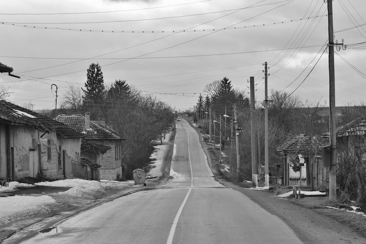 View of road in town with dilapidated houses