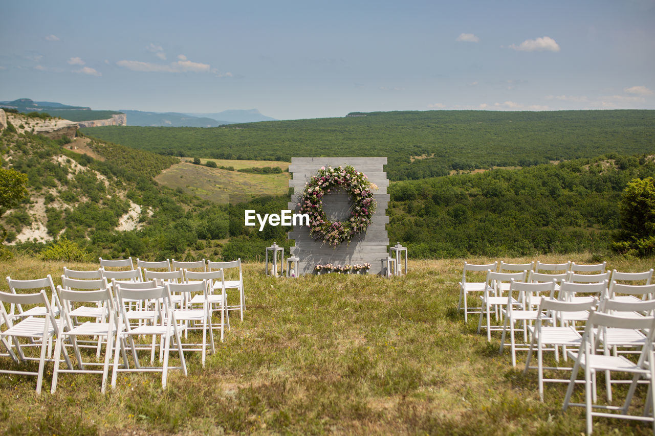 CHAIRS ON TABLE AGAINST SKY