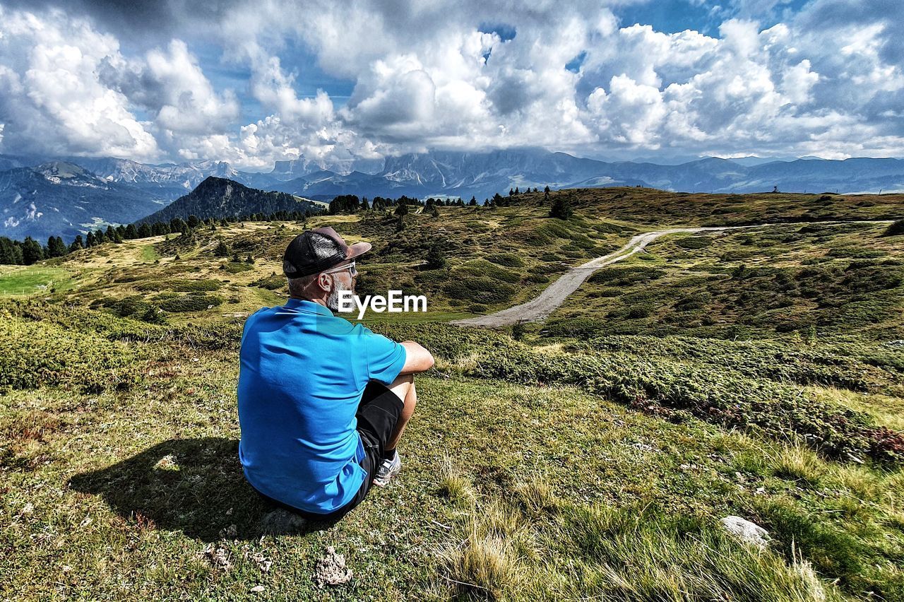 Full length of man sitting on land