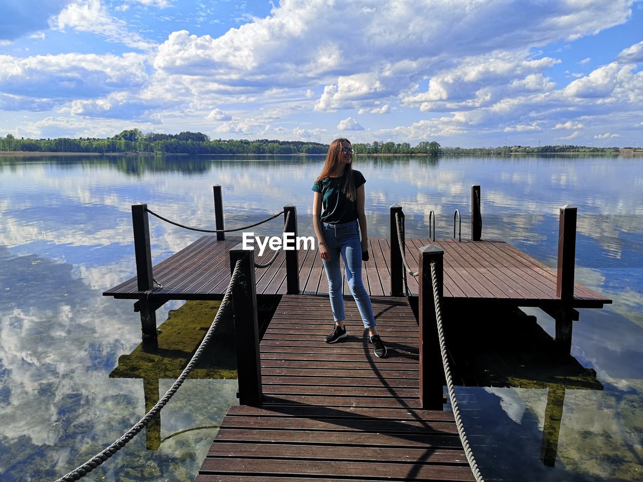 WOODEN PIER OVER LAKE AGAINST SKY