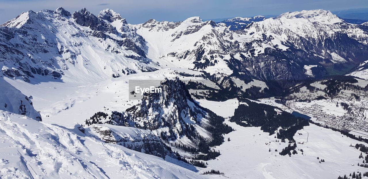 SCENIC VIEW OF SNOWCAPPED MOUNTAINS AGAINST SNOW