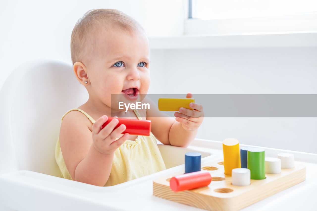 portrait of boy playing with toy blocks on table