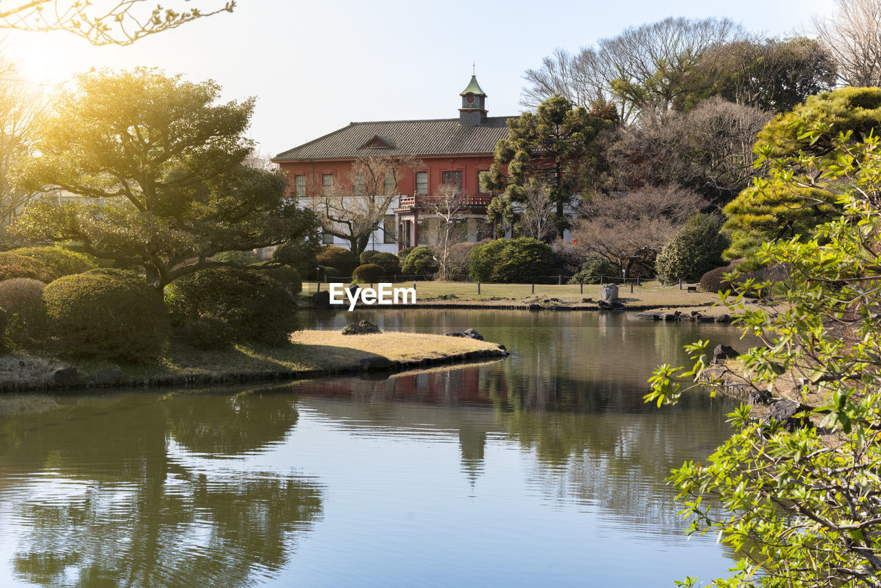 The pond of the koishikawa botanical gardens with the koishikawa annex of the university museum