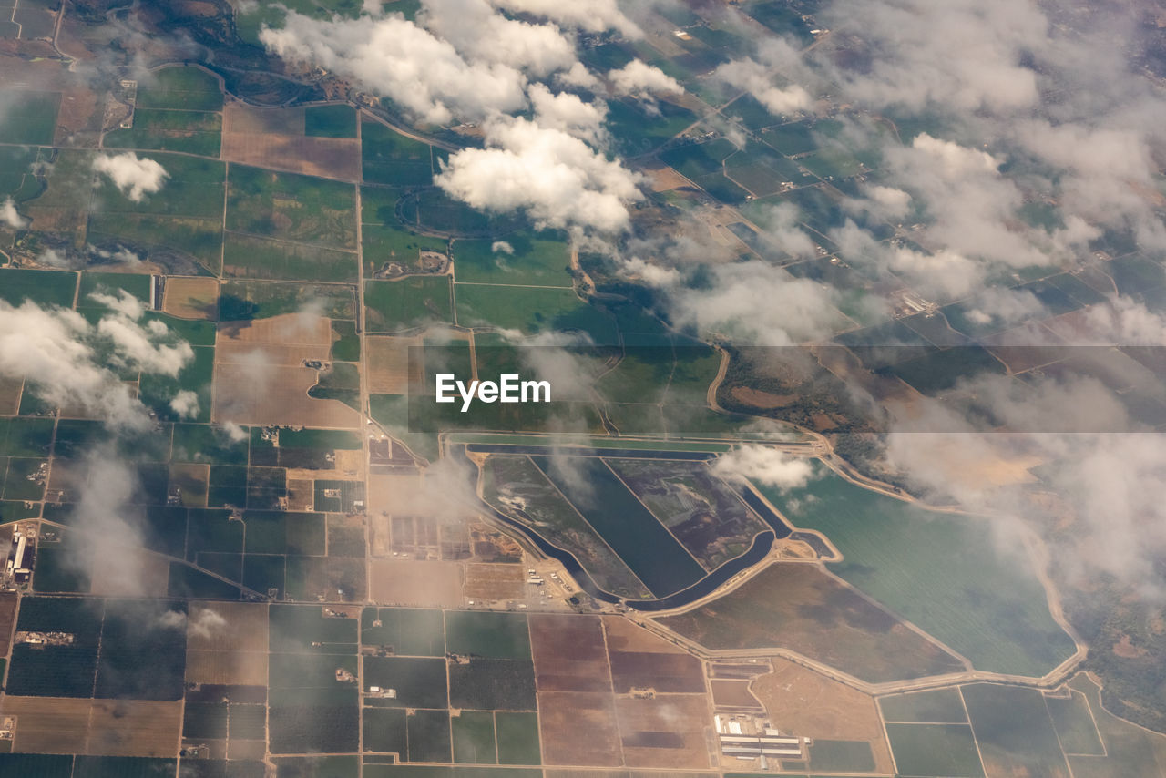 aerial photography, aerial view, environment, landscape, cloud, sky, nature, land, agriculture, architecture, rural scene, outdoors, no people, scenics - nature, field, day, transportation, airplane, city, built structure, bird's-eye view, farm, beauty in nature, building exterior, industry, building, air vehicle, business finance and industry, travel