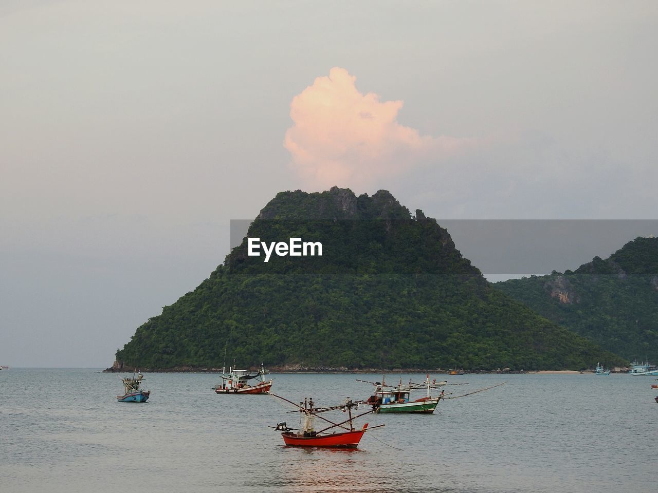 People on boat in sea against sky