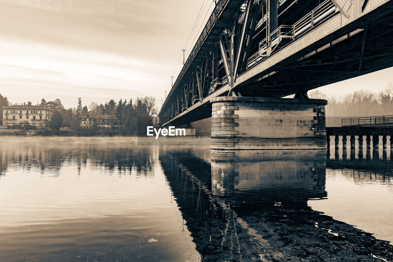 reflection, water, architecture, built structure, bridge, sky, river, nature, transportation, morning, city, building exterior, no people, monochrome, cityscape, travel destinations, black and white, cloud, monochrome photography, outdoors, urban area, tree, day, waterway, winter, travel, dusk, landscape, building