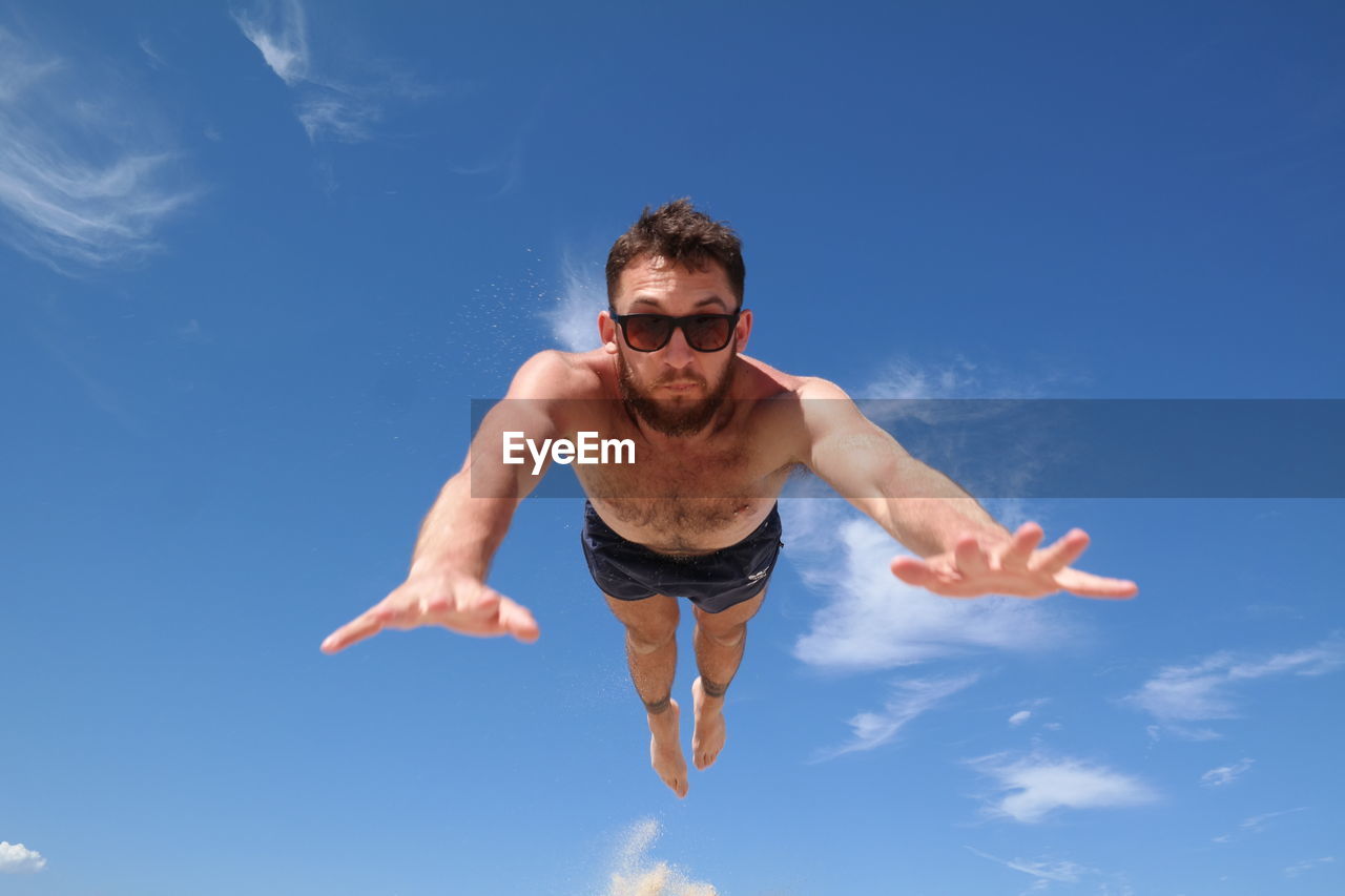 Portrait of young man against sky